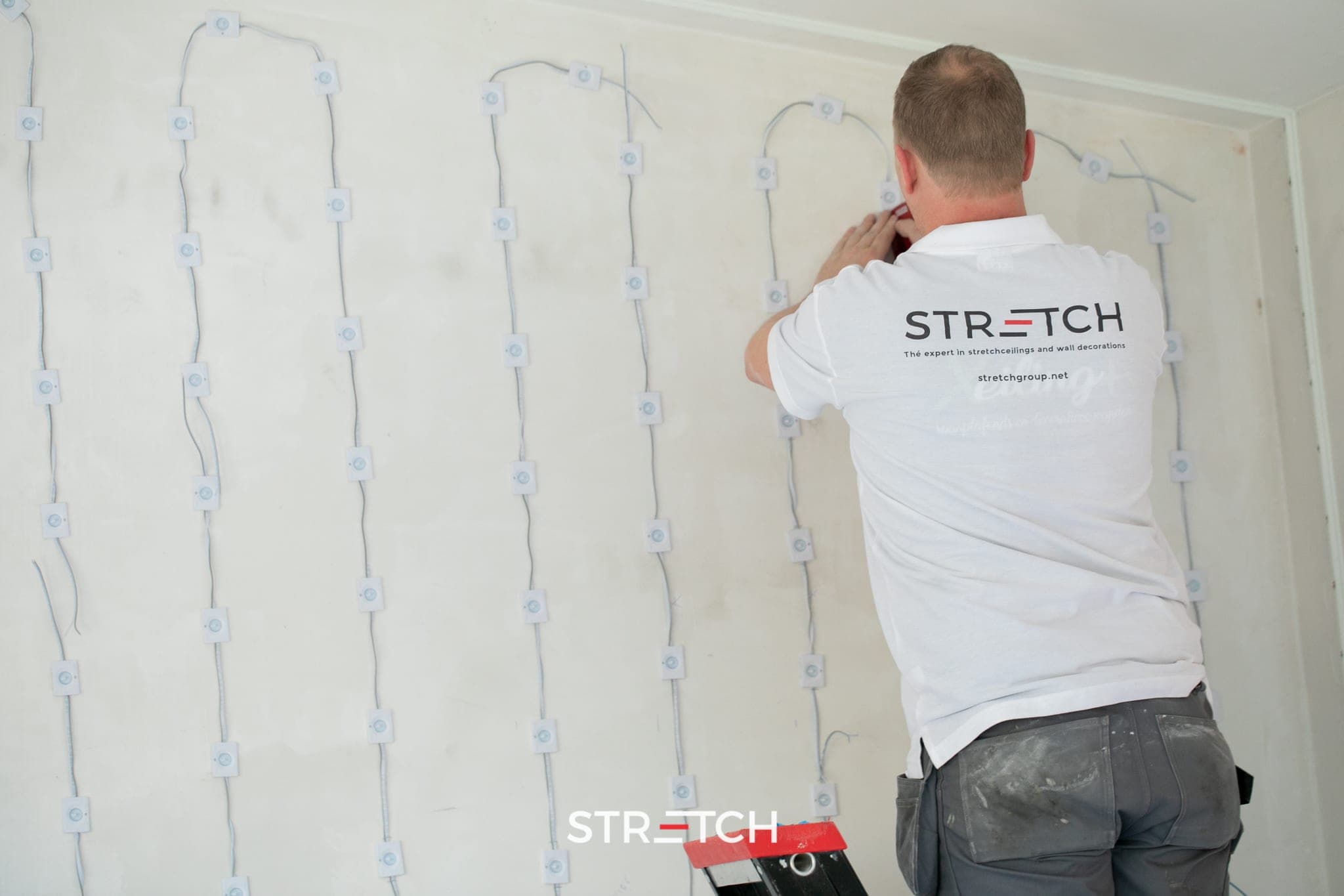 Installateur STRETCH certifié posant un plafond tendu